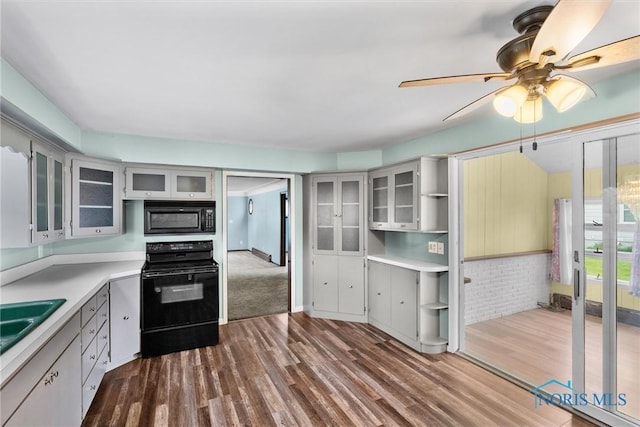503 Church St, Helena, OH 43435 - kitchen featuring black appliances, dark wood-style flooring, ceiling fan, and light countertops
