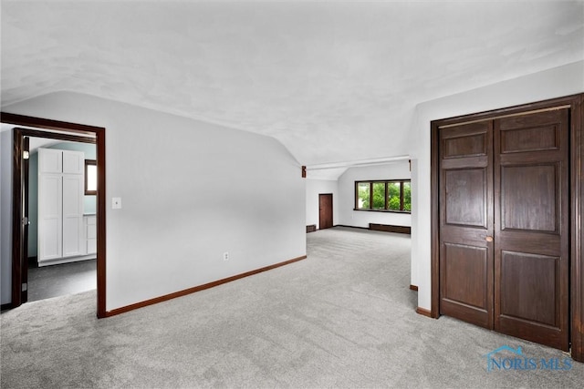 503 Church St, Helena, OH 43435 - empty room featuring lofted ceiling, carpet floors, and baseboards