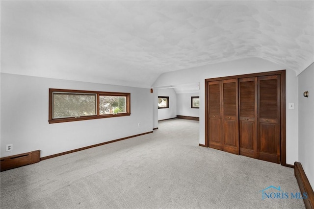 503 Church St, Helena, OH 43435 - unfurnished bedroom with lofted ceiling, carpet floors, baseboards, and a closet