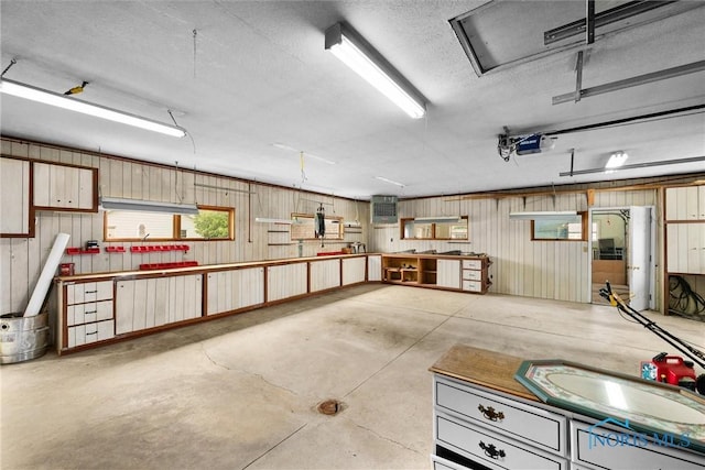 503 Church St, Helena, OH 43435 - garage featuring a garage door opener, a sink, and wood walls