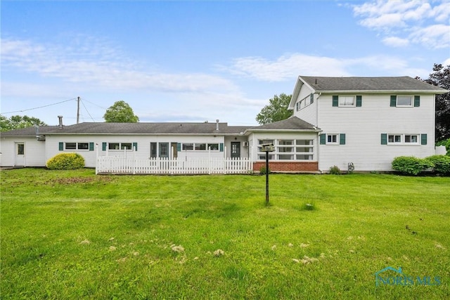 503 Church St, Helena, OH 43435 - back of house with a lawn and a sunroom