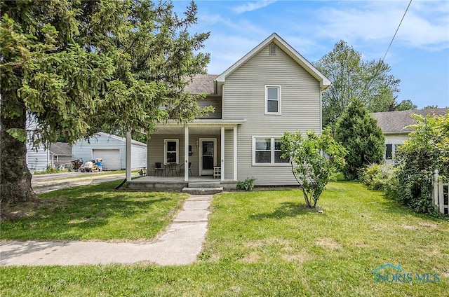 4279 Defiance Pike, Wayne, OH 43466 - traditional home featuring a porch, a front lawn, and a detached garage