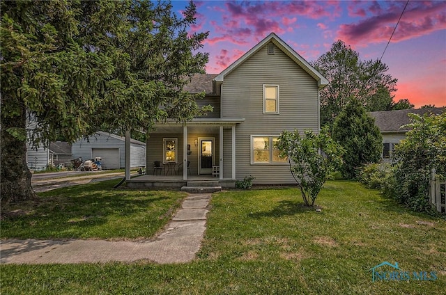 4279 Defiance Pike, Wayne, OH 43466 - traditional-style house featuring a porch, a front yard, and a detached garage