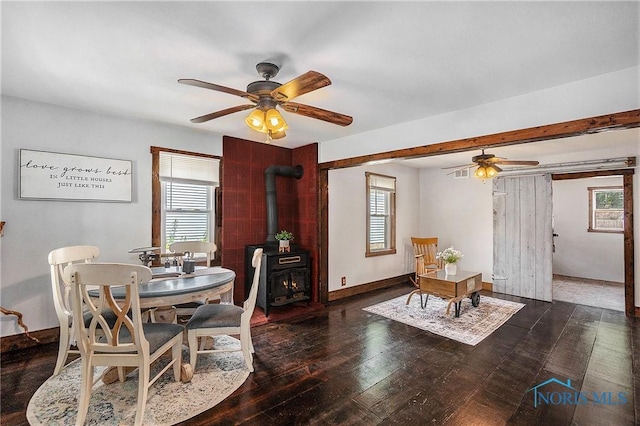 4279 Defiance Pike, Wayne, OH 43466 - dining room featuring a ceiling fan, hardwood / wood-style floors, and a wood stove