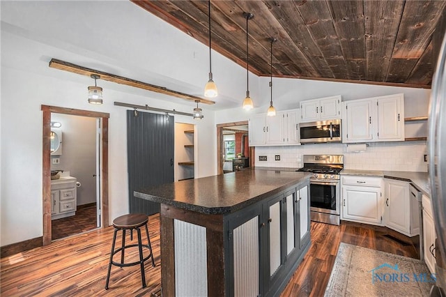 4279 Defiance Pike, Wayne, OH 43466 - kitchen with stainless steel appliances, vaulted ceiling, wood ceiling, dark wood finished floors, and dark countertops