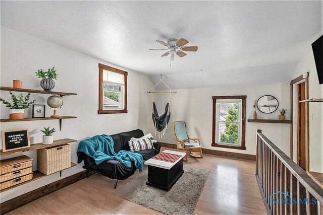4279 Defiance Pike, Wayne, OH 43466 - living area featuring wood finished floors, ceiling fan, baseboards, and vaulted ceiling