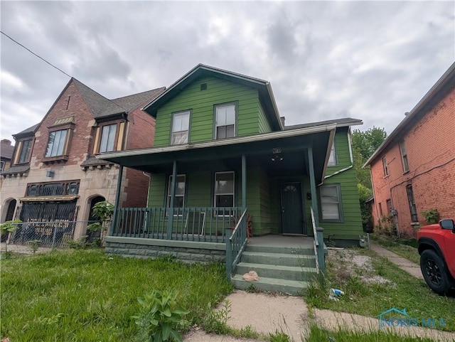 721 N Detroit Ave, Toledo, OH 43607 - view of front of house featuring covered porch and a gambrel roof