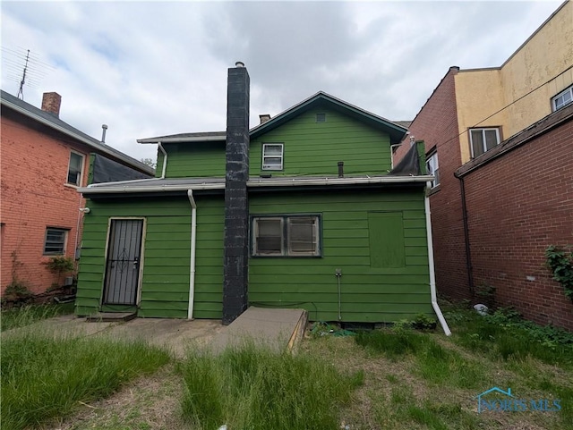 721 N Detroit Ave, Toledo, OH 43607 - rear view of house featuring a chimney