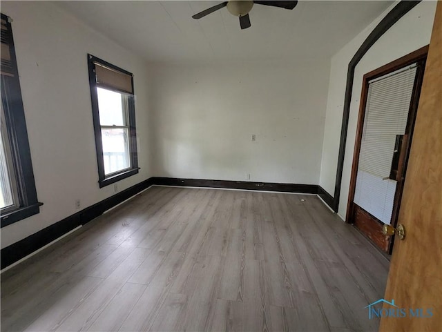 721 N Detroit Ave, Toledo, OH 43607 - spare room featuring wood finished floors, a ceiling fan, and baseboards
