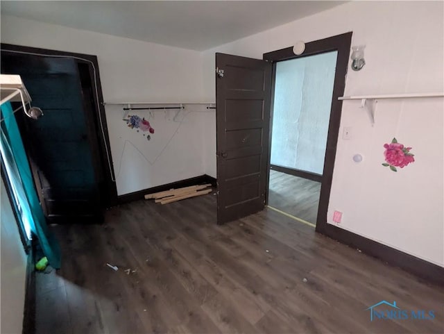 721 N Detroit Ave, Toledo, OH 43607 - unfurnished bedroom with dark wood-style floors and baseboards