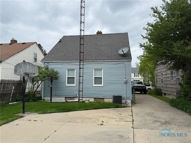 1507 Crestwood Rd, Toledo, OH 43612 - rear view of property with cooling unit, a shingled roof, and a chimney