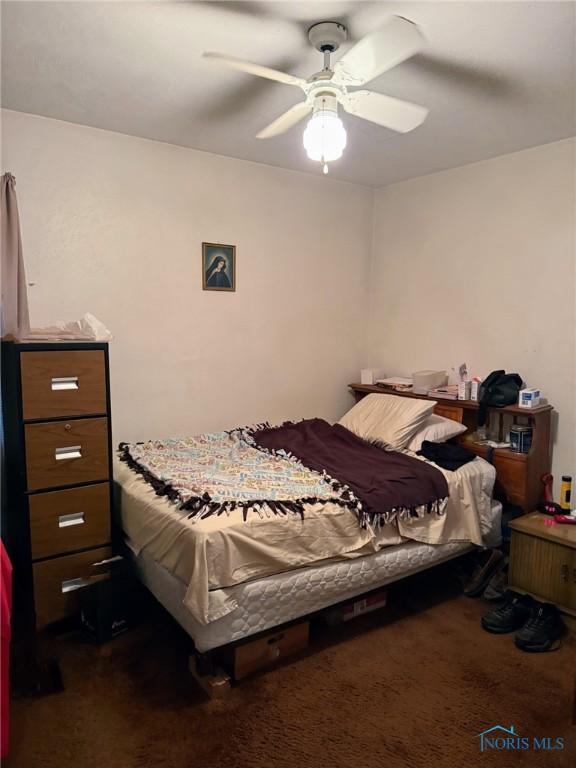 1507 Crestwood Rd, Toledo, OH 43612 - bedroom with dark carpet and a ceiling fan