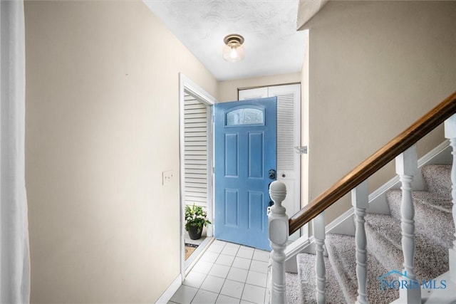 119 Mallard Rd, Perrysburg, OH 43551 - foyer entrance with stairs, light tile patterned floors, and baseboards