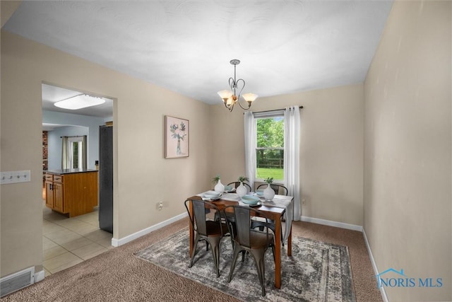119 Mallard Rd, Perrysburg, OH 43551 - dining space featuring light colored carpet, a chandelier, and baseboards