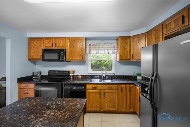 119 Mallard Rd, Perrysburg, OH 43551 - kitchen with black appliances, a sink, brown cabinetry, and light tile patterned floors