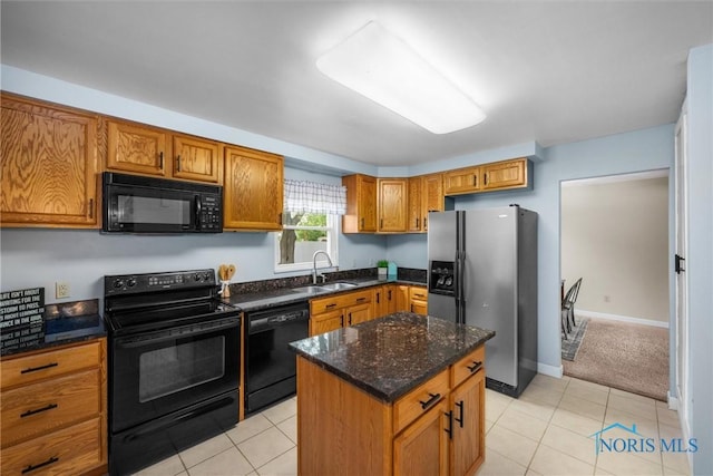 119 Mallard Rd, Perrysburg, OH 43551 - kitchen featuring black appliances, a sink, brown cabinets, and light tile patterned floors