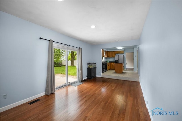 119 Mallard Rd, Perrysburg, OH 43551 - unfurnished living room with light wood-style flooring, baseboards, and recessed lighting