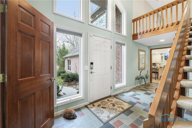 8801 W Bancroft St, Toledo, OH 43617 - entryway featuring stairs, a high ceiling, and baseboards
