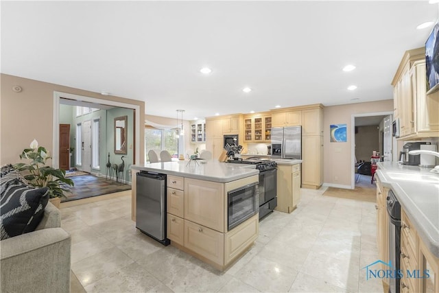 8801 W Bancroft St, Toledo, OH 43617 - kitchen featuring stainless steel refrigerator with ice dispenser, black range with gas cooktop, light countertops, built in microwave, and a kitchen island