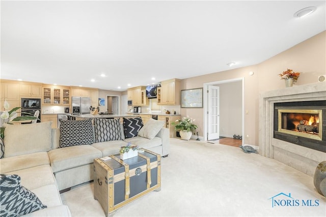 8801 W Bancroft St, Toledo, OH 43617 - living room featuring a high end fireplace, light carpet, recessed lighting, and baseboards