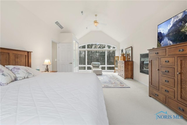 8801 W Bancroft St, Toledo, OH 43617 - bedroom with light carpet, vaulted ceiling, a glass covered fireplace, and ceiling fan