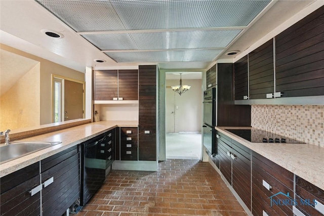 1250 Hidden Ridge Rd, Toledo, OH 43615 - kitchen with black appliances, a chandelier, decorative backsplash, light countertops, and a sink