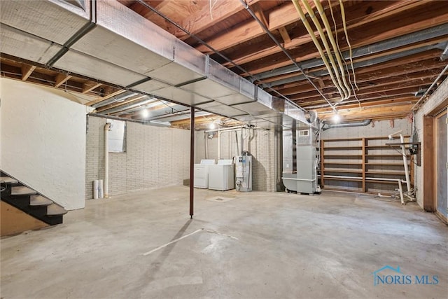 1250 Hidden Ridge Rd, Toledo, OH 43615 - unfinished below grade area featuring washing machine and dryer, water heater, stairway, and heating unit
