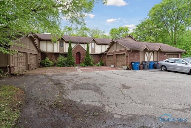 1250 Hidden Ridge Rd, Toledo, OH 43615 - tudor house featuring brick siding and board and batten siding