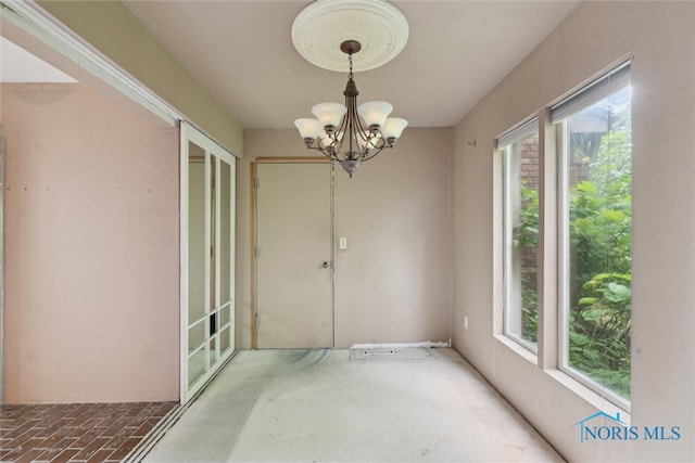 1250 Hidden Ridge Rd, Toledo, OH 43615 - spare room with healthy amount of natural light and a chandelier