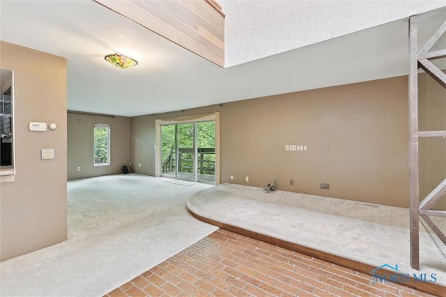 1250 Hidden Ridge Rd, Toledo, OH 43615 - carpeted empty room with brick patterned flooring