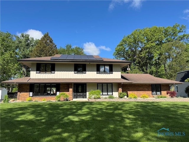 3759 Rose Glenn Dr, Toledo, OH 43615 - view of front of property with a front lawn, solar panels, and brick siding