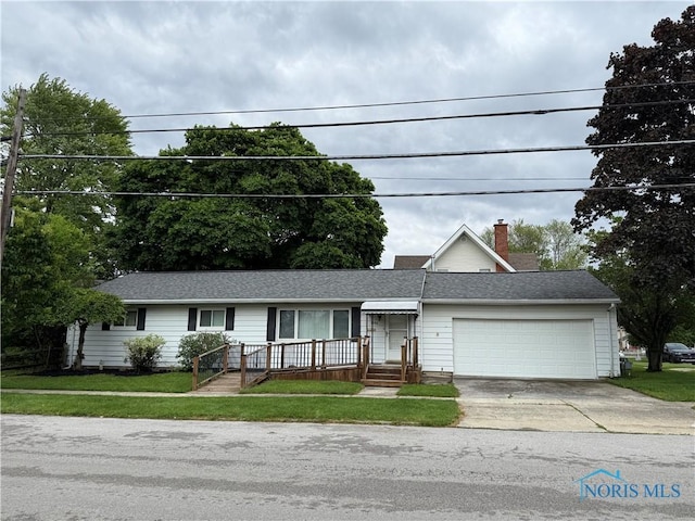 1306 N Union St, Fostoria, OH 44830 - ranch-style house with a garage, concrete driveway, a front yard, and a chimney
