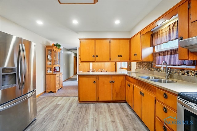 1306 N Union St, Fostoria, OH 44830 - kitchen featuring stainless steel refrigerator with ice dispenser, a sink, light wood-style flooring, light countertops, and recessed lighting