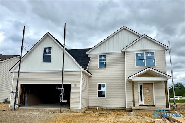 1912 Caleb Ct, Waterville, OH 43566 - view of front of house with an attached garage, dirt driveway, and roof with shingles