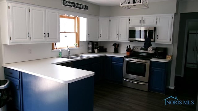 640 Hemlock St, Wauseon, OH 43567 - kitchen featuring appliances with stainless steel finishes, white cabinets, a peninsula, and light countertops