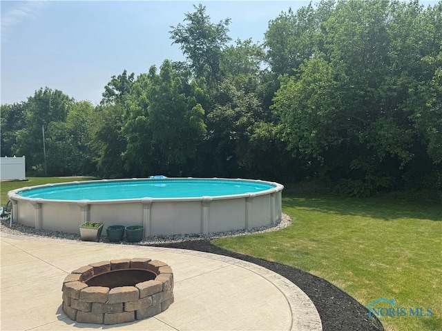 640 Hemlock St, Wauseon, OH 43567 - outdoor pool featuring a fire pit and a lawn