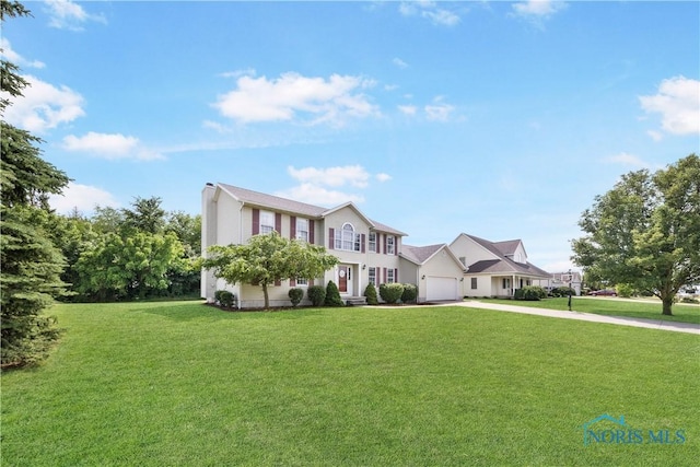 640 Hemlock St, Wauseon, OH 43567 - colonial inspired home featuring driveway, a front lawn, and an attached garage