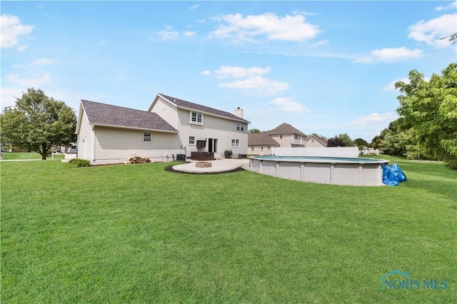640 Hemlock St, Wauseon, OH 43567 - back of house with a yard, an outdoor pool, and a patio