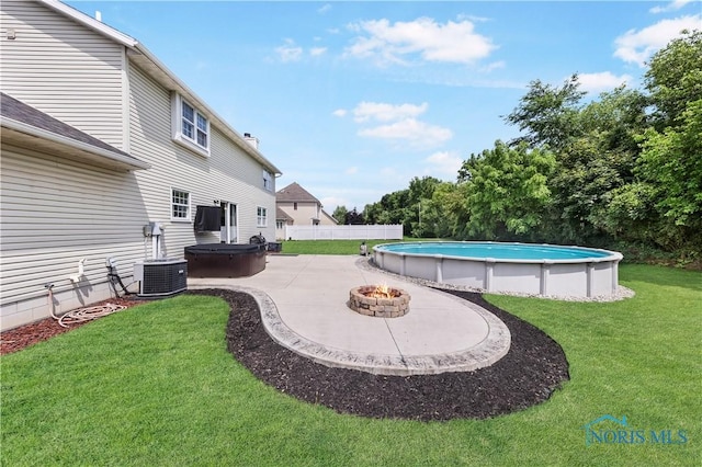 640 Hemlock St, Wauseon, OH 43567 - swimming pool featuring a hot tub, a patio area, and an outdoor fire pit
