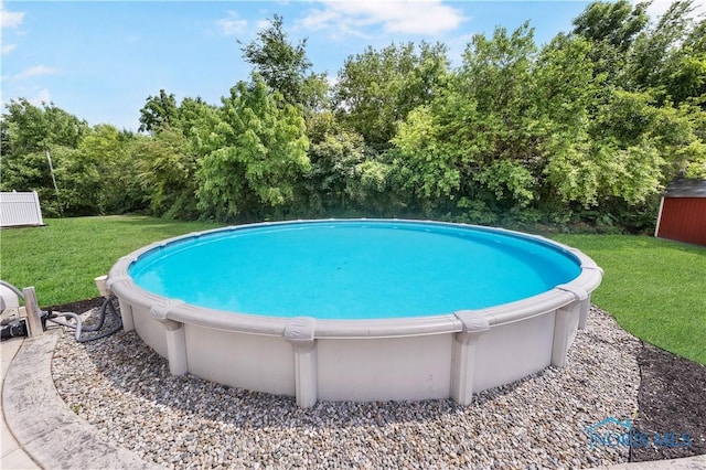 640 Hemlock St, Wauseon, OH 43567 - swimming pool featuring a yard and view of wooded area