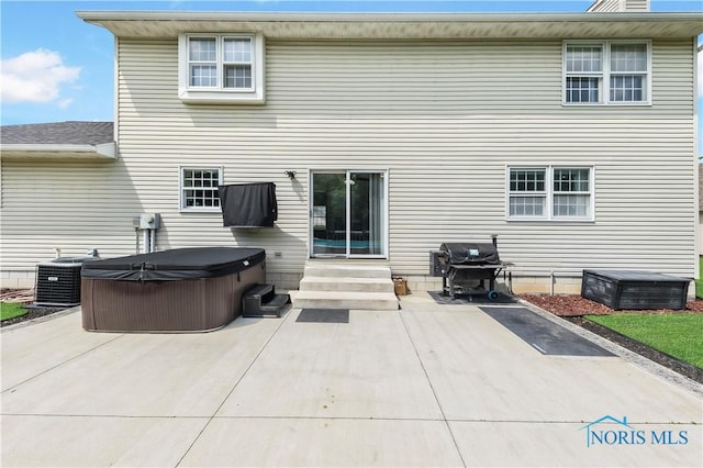 640 Hemlock St, Wauseon, OH 43567 - back of house with a hot tub and a patio