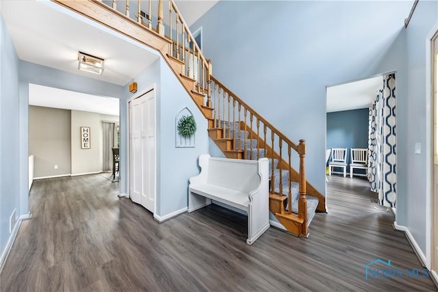 640 Hemlock St, Wauseon, OH 43567 - staircase featuring wood finished floors and a towering ceiling