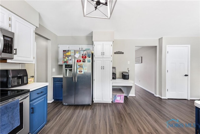 640 Hemlock St, Wauseon, OH 43567 - kitchen with appliances with stainless steel finishes, blue cabinetry, dark wood finished floors, light countertops, and white cabinetry