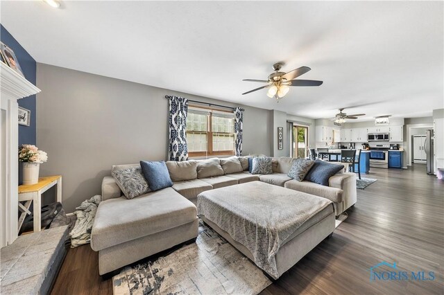 640 Hemlock St, Wauseon, OH 43567 - living area featuring a ceiling fan and dark wood-style floors