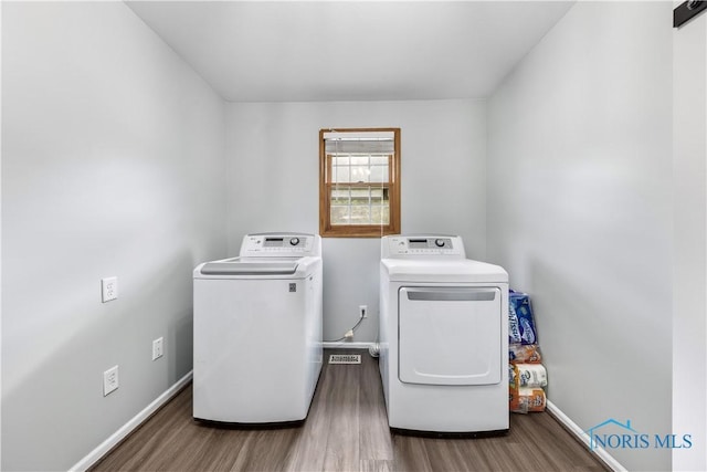 640 Hemlock St, Wauseon, OH 43567 - washroom with washing machine and dryer and wood finished floors