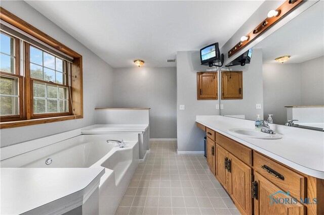 640 Hemlock St, Wauseon, OH 43567 - full bathroom with plenty of natural light, vanity, a bath, and tile patterned floors