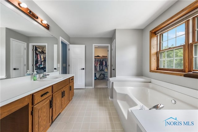640 Hemlock St, Wauseon, OH 43567 - bathroom featuring a spacious closet, a bath, and vanity