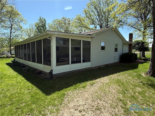 20642 Buckskin Rd, Defiance, OH 43512 - view of home's exterior with a sunroom, a lawn, and a chimney