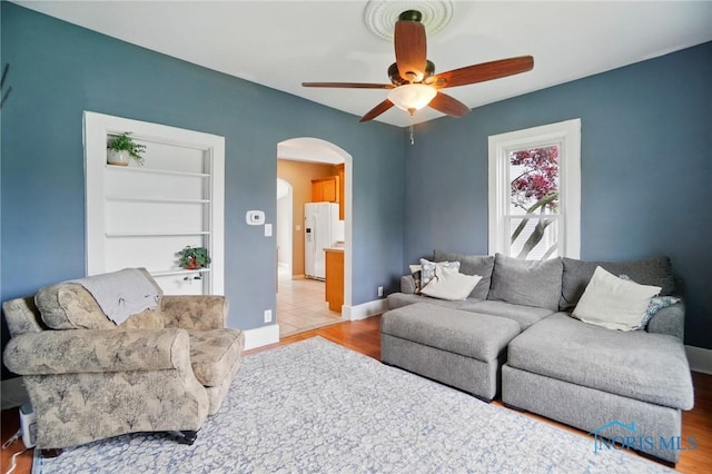 404 W Yates Ave, Findlay, OH 45840 - living room with arched walkways, a ceiling fan, wood finished floors, and baseboards