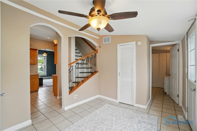 404 W Yates Ave, Findlay, OH 45840 - interior space featuring ceiling fan, arched walkways, light tile patterned flooring, baseboards, and vaulted ceiling